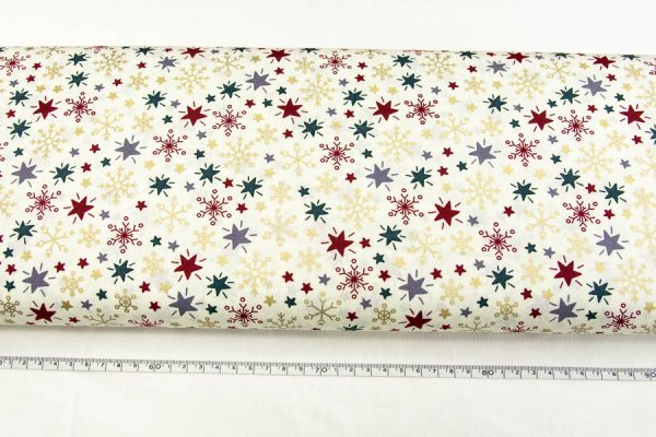 Kolorowe śnieżynki i gwiazdki na kremie - tkanina bawełniana